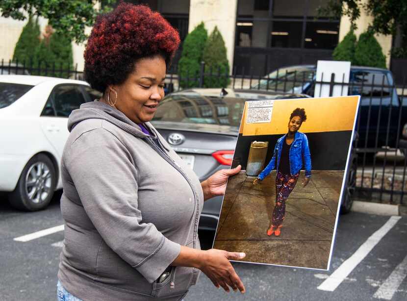 Shaquna Persley holds a picture of her daughter, Shavon Randle, outside  the Earle Cabell...