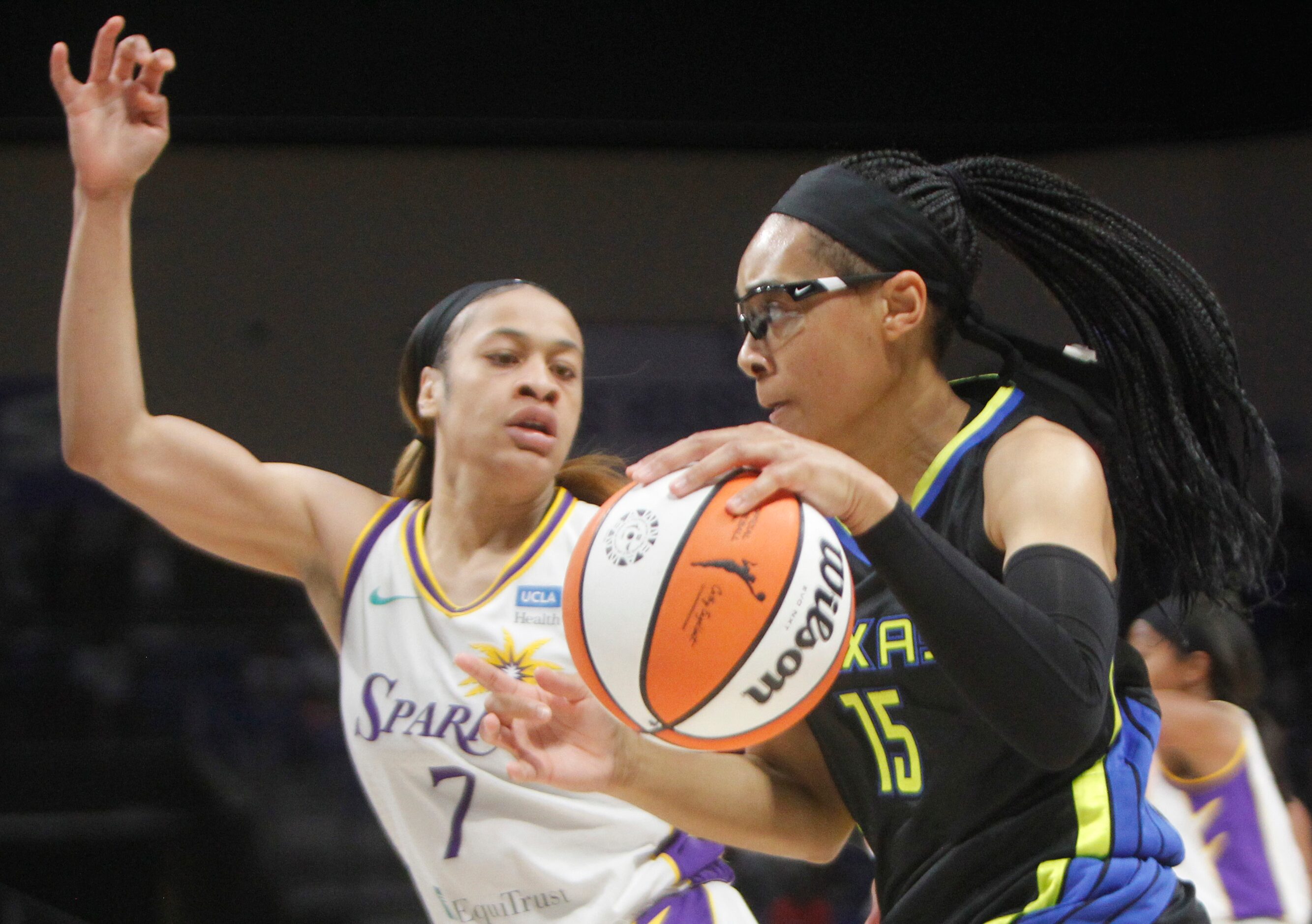 Dallas Wings guard Allisha Gray (15) drives to the basket past the defense of LA Sparks...