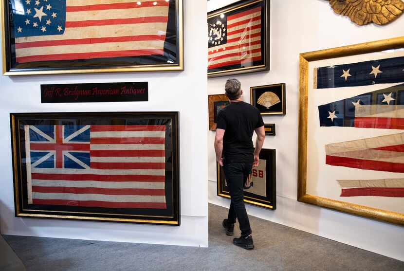 Dorsey looks at a selection of framed flags at Jeff R Bridgman American Antiques.