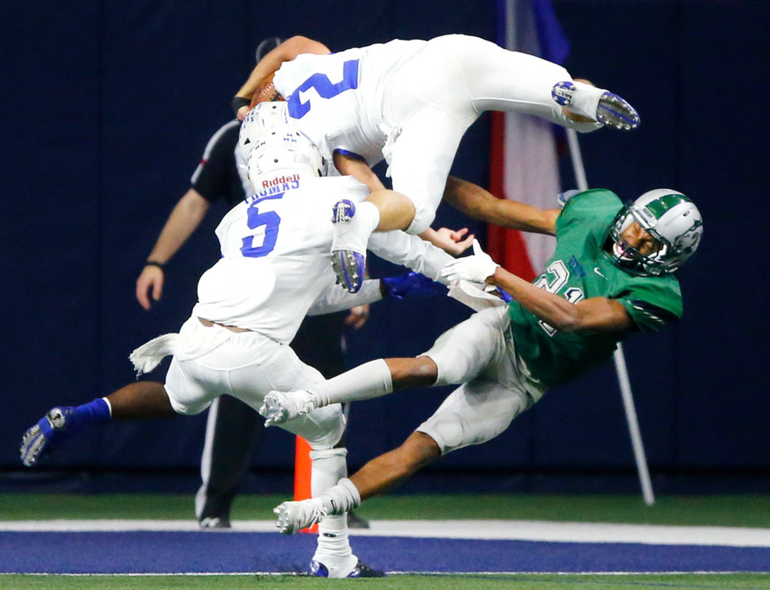 Midlothian running back Nolan Samek (2) goes over Frisco Reedy cornerback Darius Blackmon...