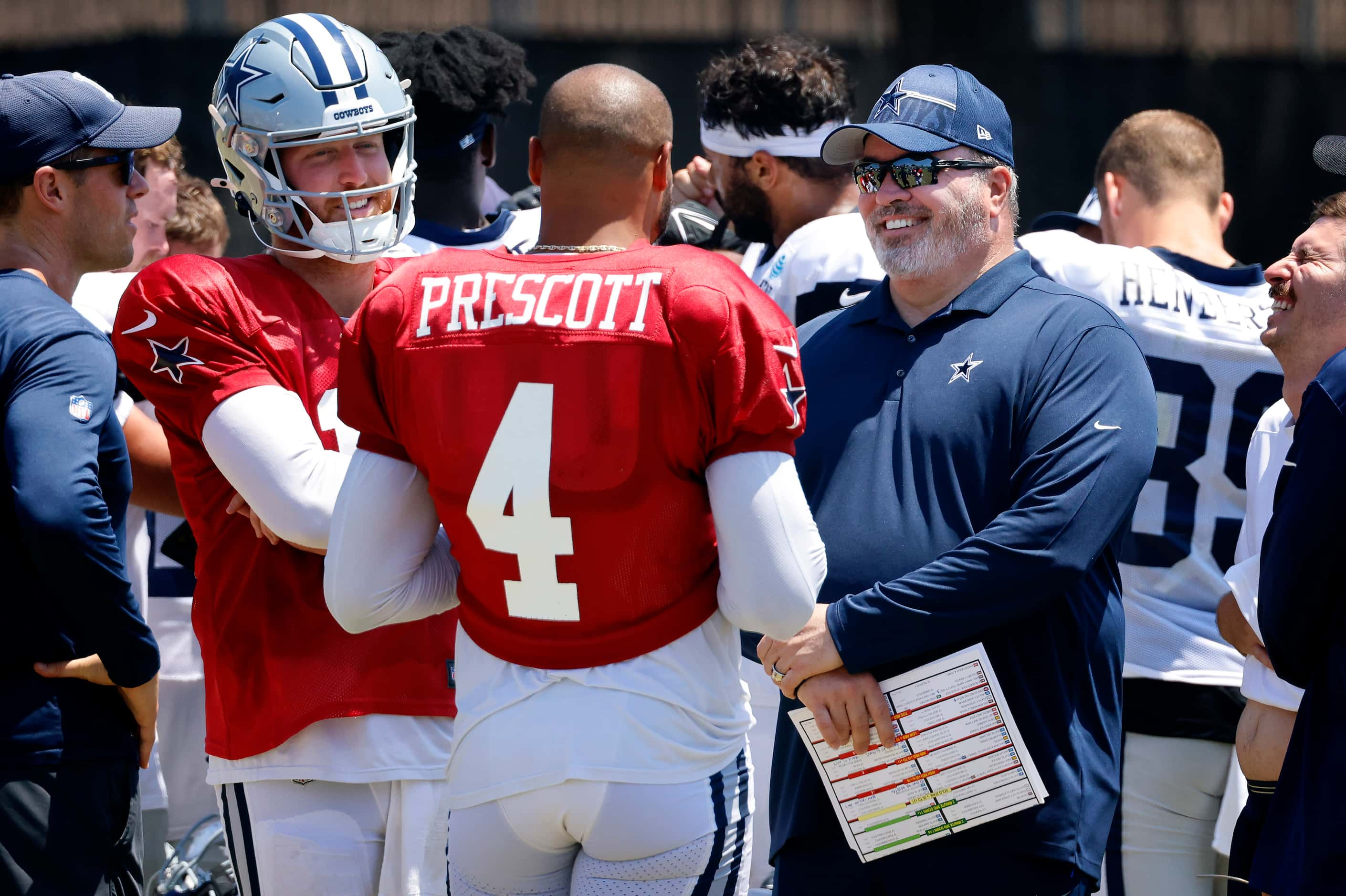 Dallas Cowboys head coach Mike McCarthy  visits with quarterbacks Dak Prescott (4) and...