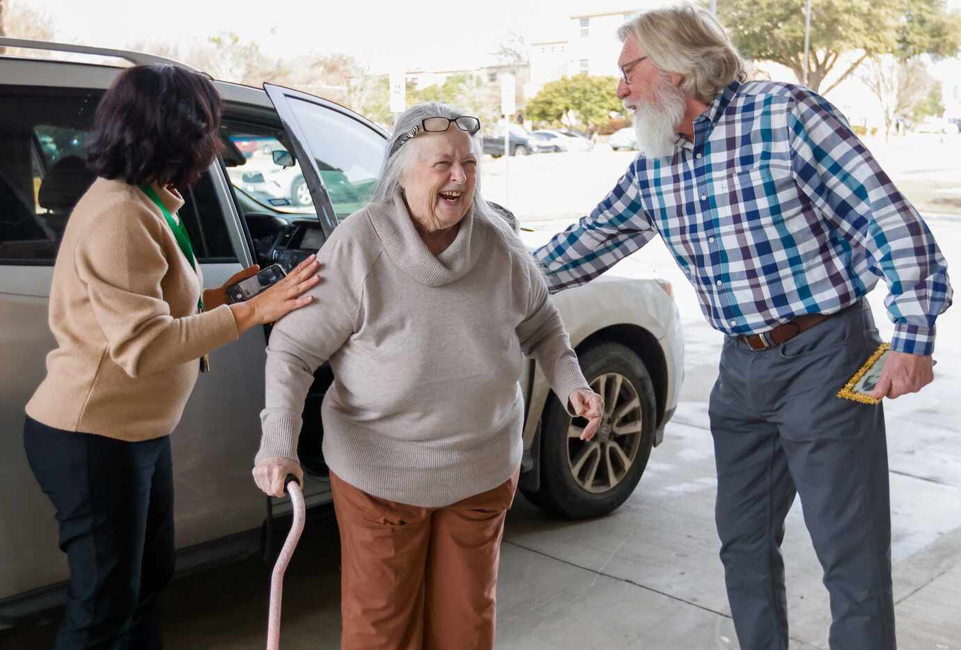 Poldi Tonin (center) is helped out of the car at Tonin’s new complex Juliette Fowler...