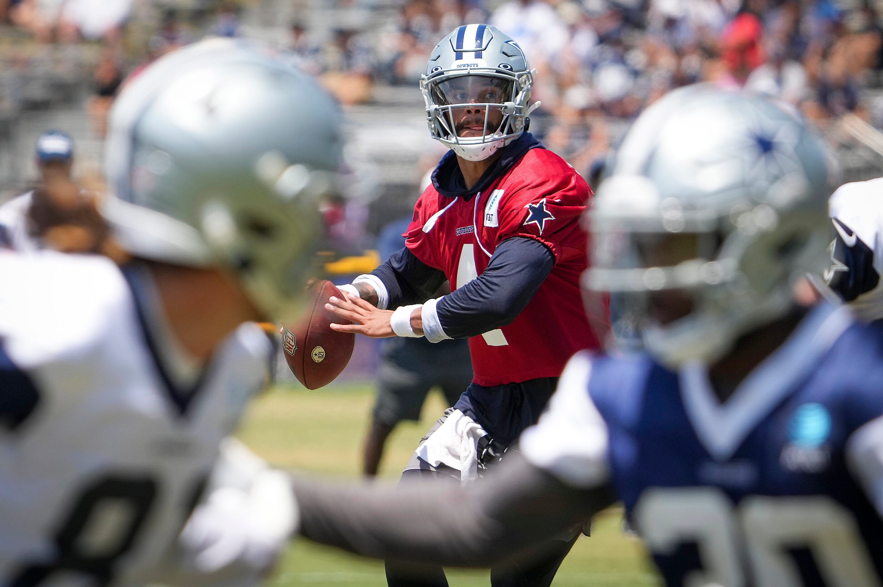 Dallas Cowboys quarterback Dak Prescott (4) looks for a receiver during a practice at...