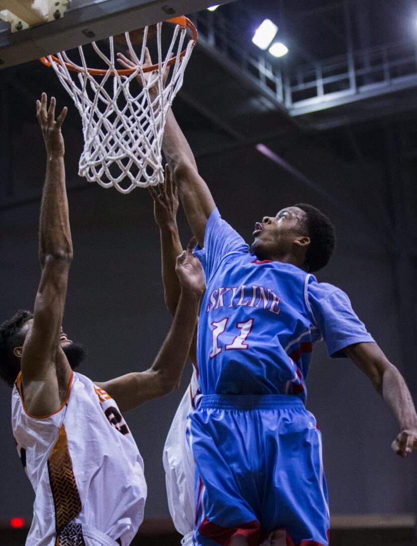 Skyline's Terrion Randolph (11) goes up for a shot against Lancaster's Nate Morris (32)...