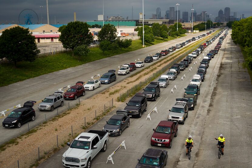 Cars lined up for a North Texas Food Bank free food distribution at Fair Park in Dallas on...