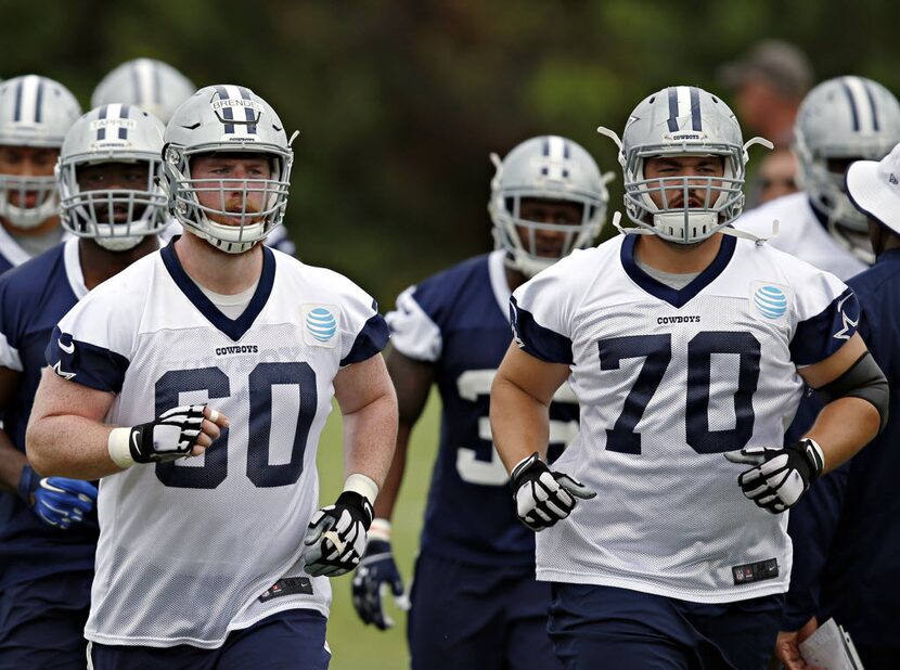 Dallas Cowboys center Jake Brendel (left) and guard Zack Martin run to a drill during OTA's...