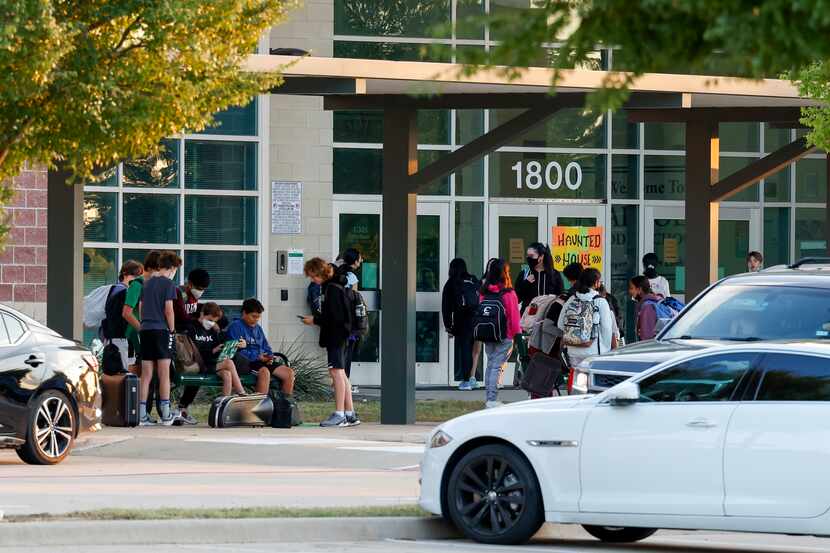 Students walk into Carroll Middle School in Southlake before the start of classes. Teachers...