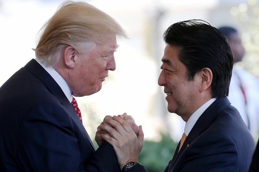 President Donald Trump greets Japanese Prime Minister Shinzo Abe as he arrives at the White...