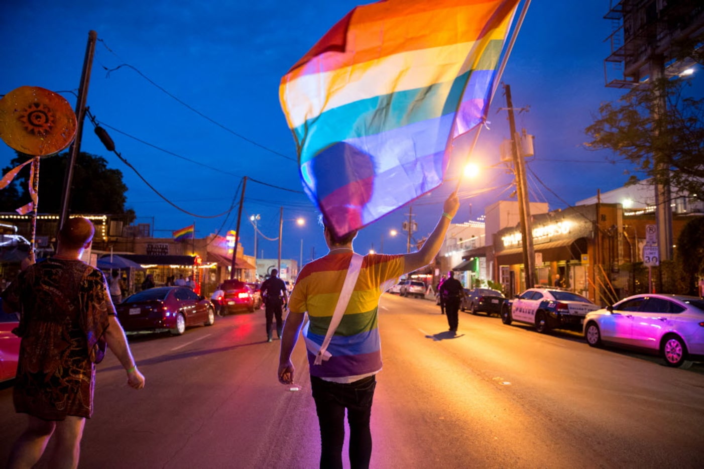 Zach Cussins marches with the Rainbow Flag during the Queer Bomb Dallas procession march...