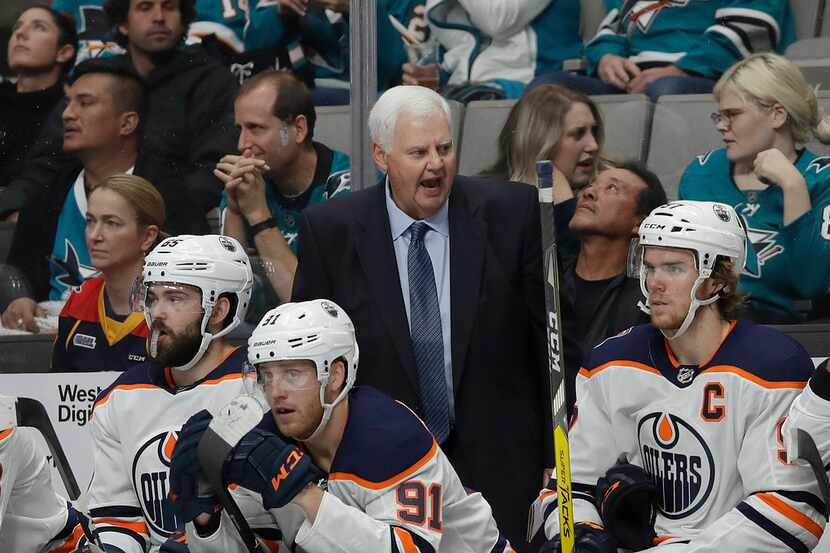 Edmonton Oilers head coach Ken Hitchcock talks to his players during the second period of an...
