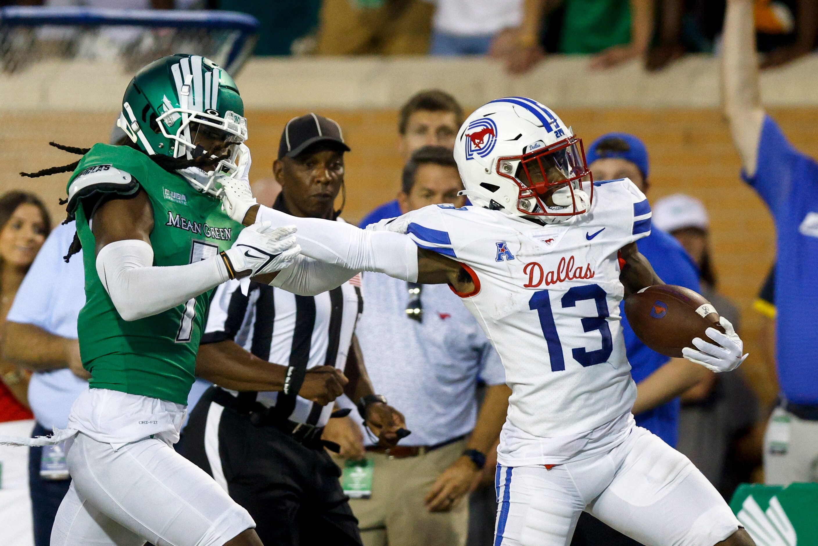 SMU wide receiver Roderick Daniels Jr. (13) stiff-arms UNT defensive back Quinn Whitlock (7)...