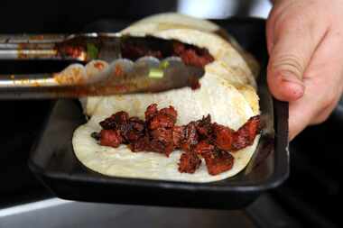 La Huasteca serves pork street tacos at Taste of Dallas in Fair Park on June 14, 2015.