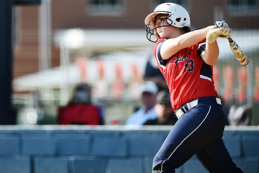 Ryan Lady Raider Abby Buettner (33) watches the ball fly into outfield as her team faced off...