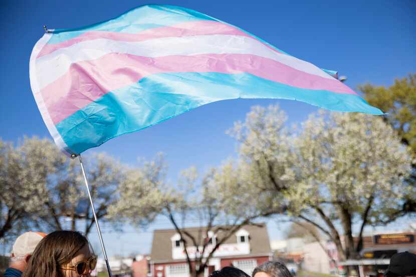 Protestors flying the transgender flag gather at the University of Texas Southwestern...