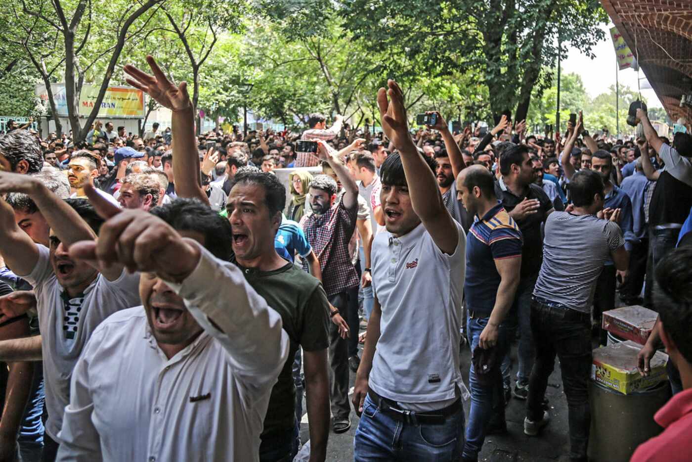 A group of protesters chant slogans at the old grand bazaar in Tehran, Iran, Monday, June...