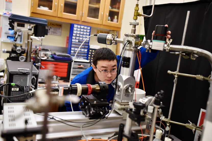Graduate student Zhong Wang inspects equipment and devices that are used to transfer heat at...