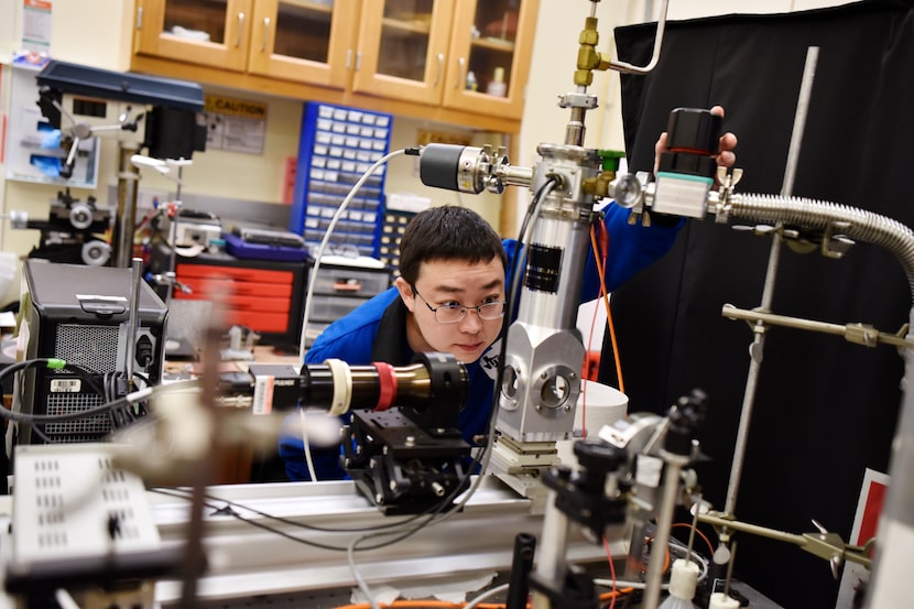 Graduate student Zhong Wang inspects equipment and devices that are used to transfer heat at...