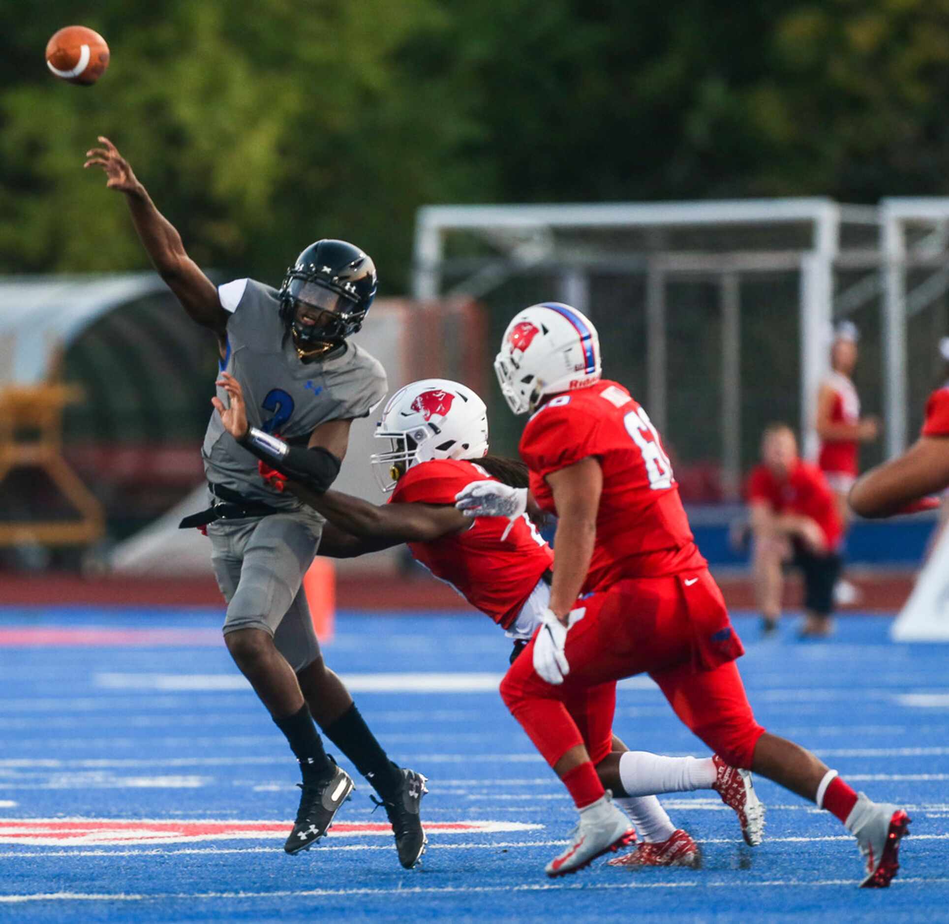 Trinity Christian-Cedar Hills quarterback Shedeur Sanders (2) fires off a pass as he breaks...