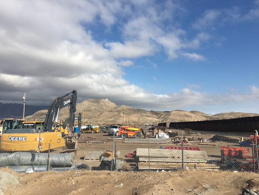 Construction crews replace a section of aging border fence in Sunland Park, N.M., with an...