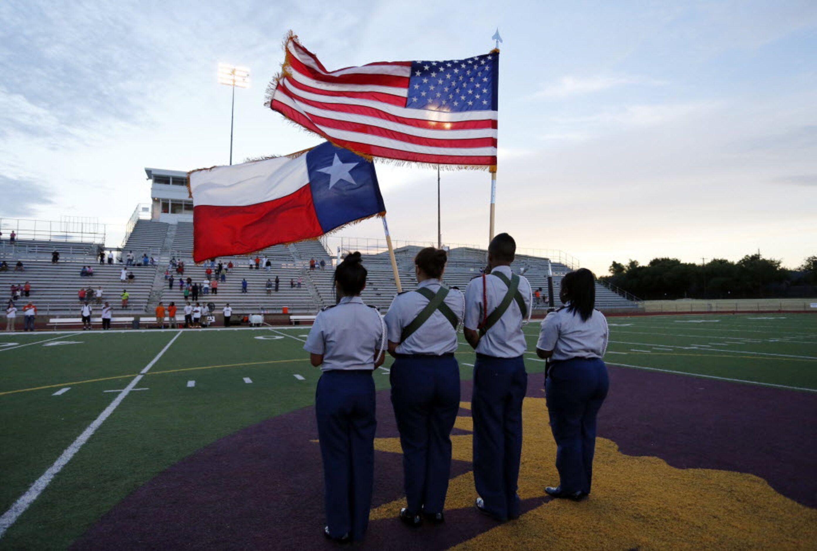 (TXHSFB) North Dallas High ROTC members stand at attention at midfield during the playing of...