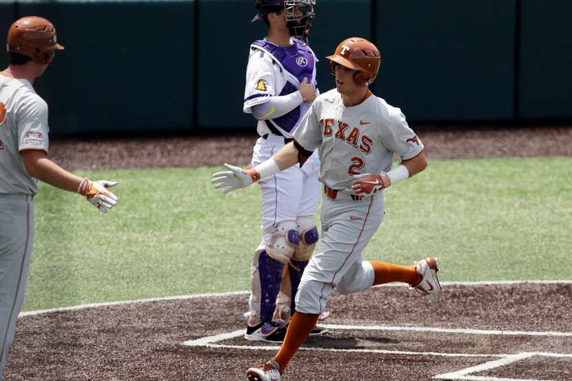 Texas infielder Kody Clemens (2) crosses the plate after hitting a home run against...