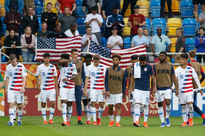 United States players walk on the pitch after their team's 1-2 loss during the quarter final...