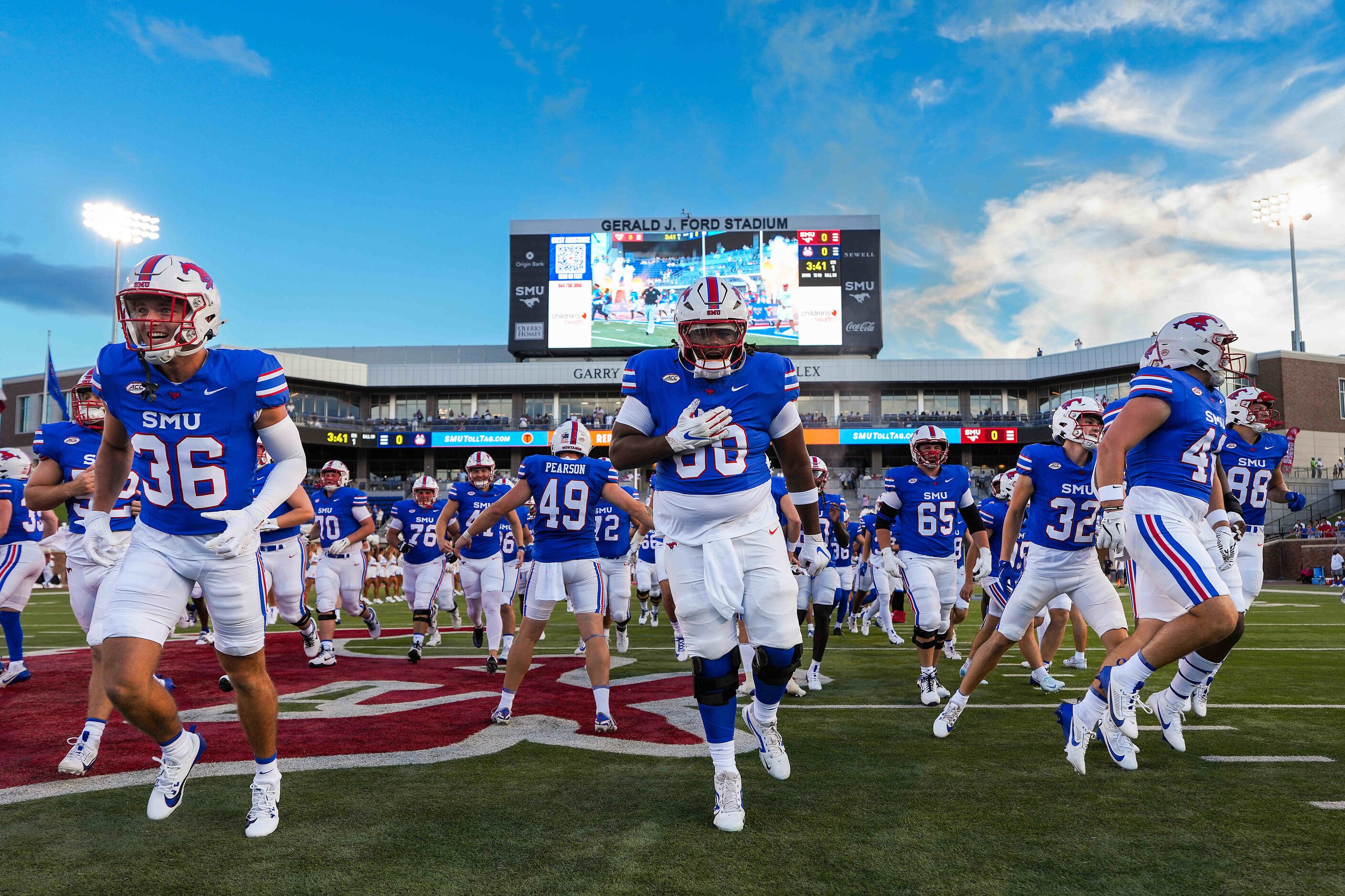 SMU players, including offensive lineman King Large (68) run from the the brand new Garry...