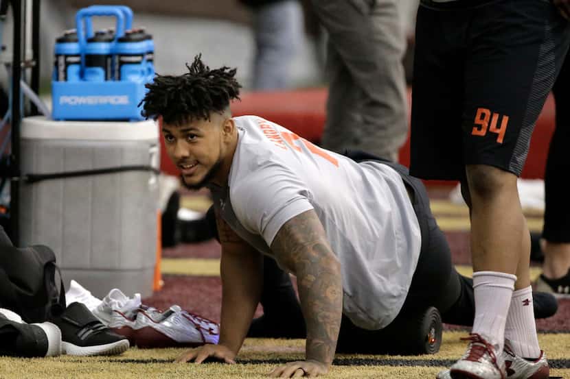 Boston College football defensive end Harold Landry uses a roller on his muscles during BC...