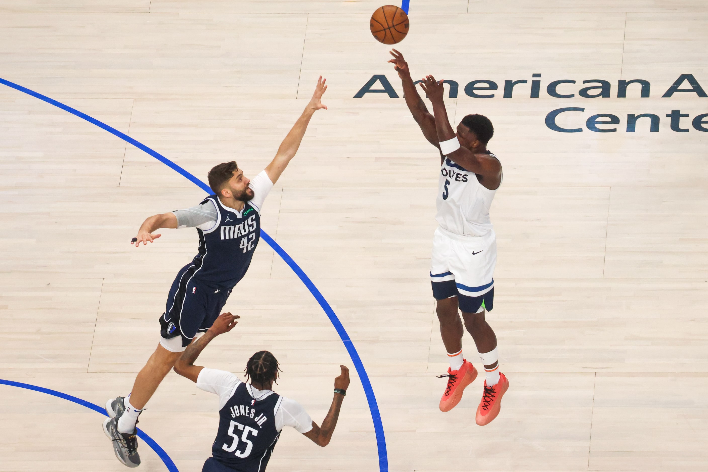 Minnesota Timberwolves guard Anthony Edwards shoots a 3-pointer over Dallas Mavericks...