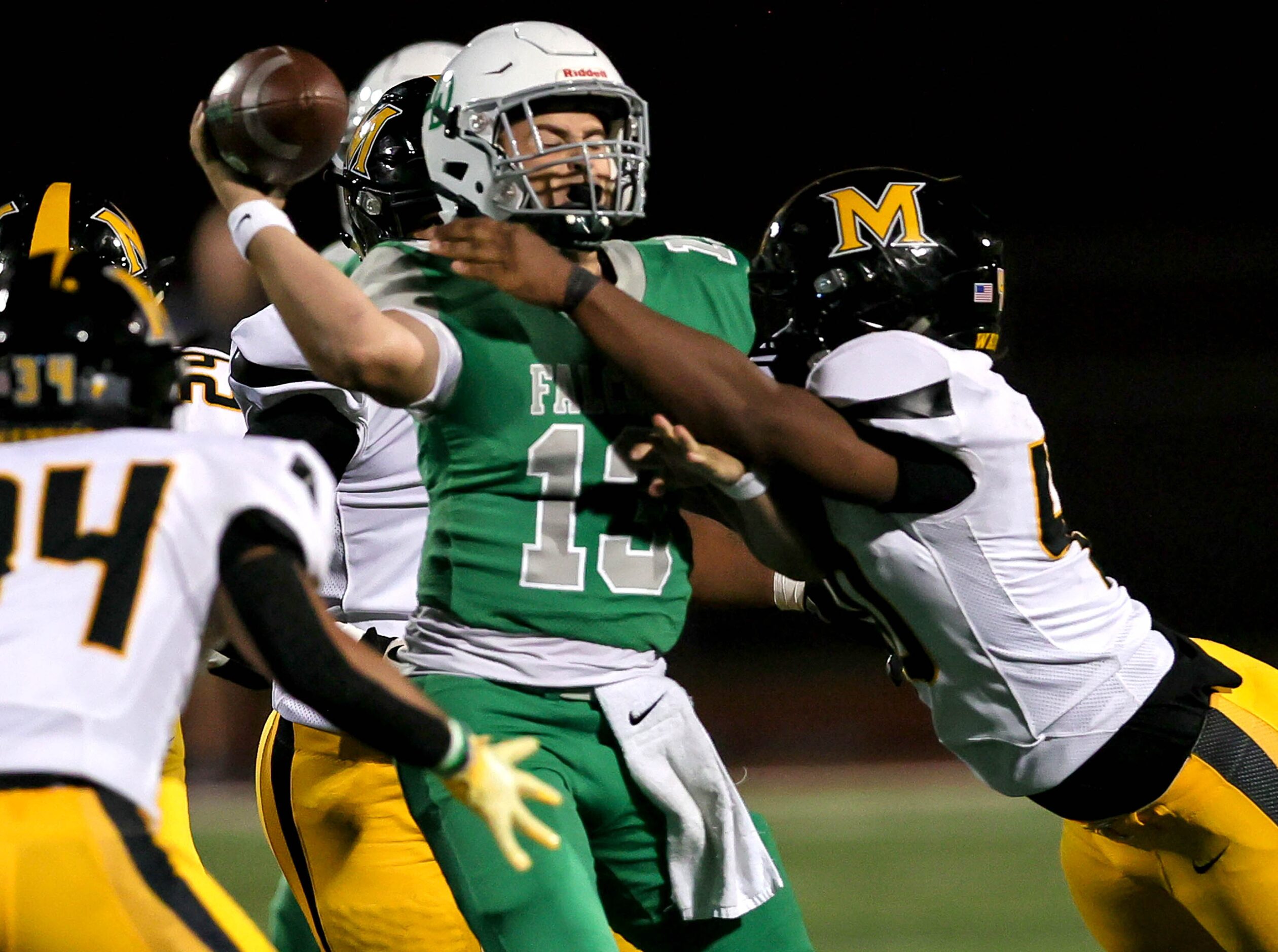 Lake Dallas quarterback Cade Bortnem (13) tries to get off a pass against Frisco Memorial...