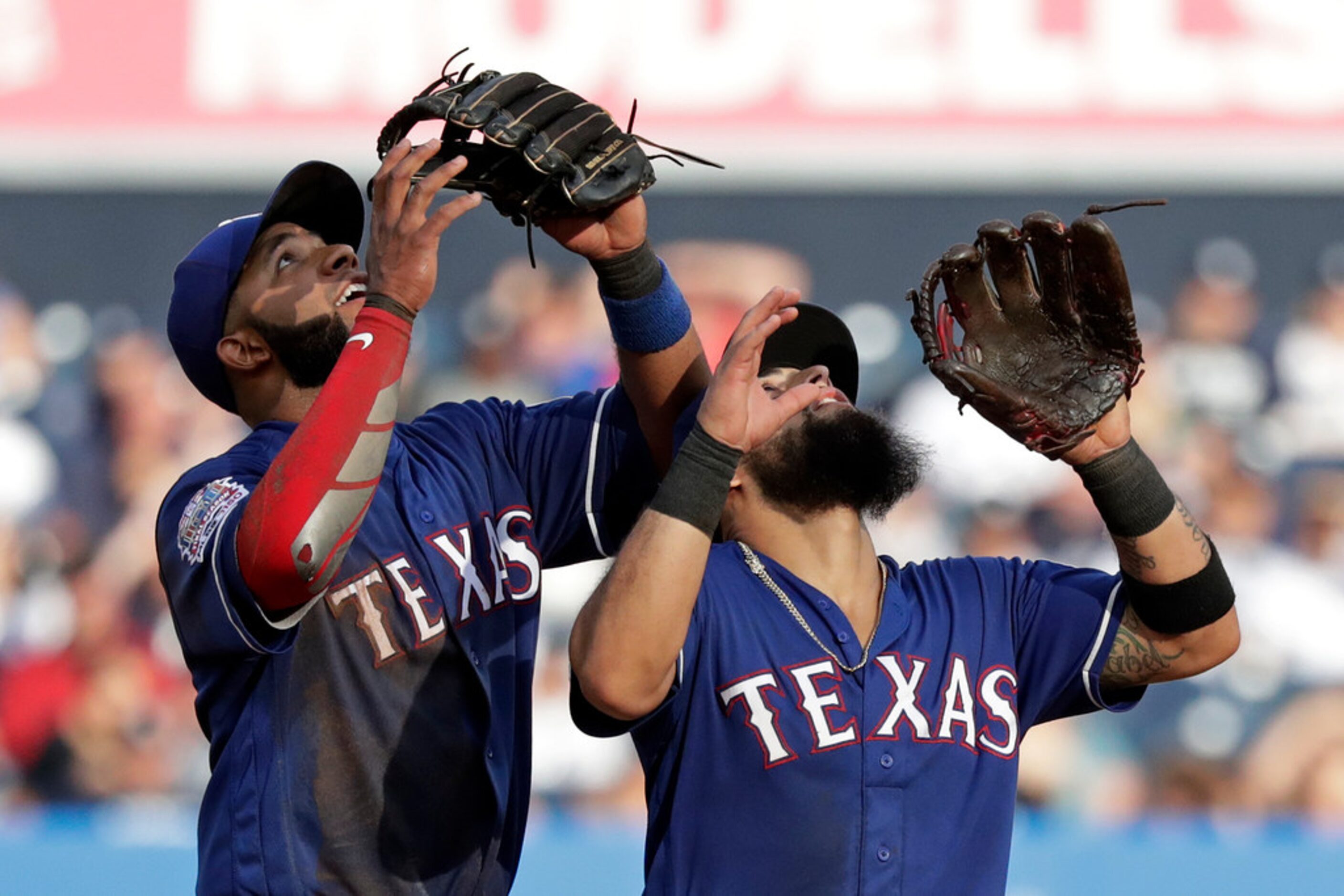 Texas Rangers shortstop Elvis Andrus, left, and second baseman Rougned Odor settle under a...