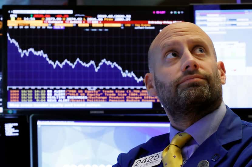 Specialist Meric Greenbaum works at his post on the floor of the New York Stock Exchange,...