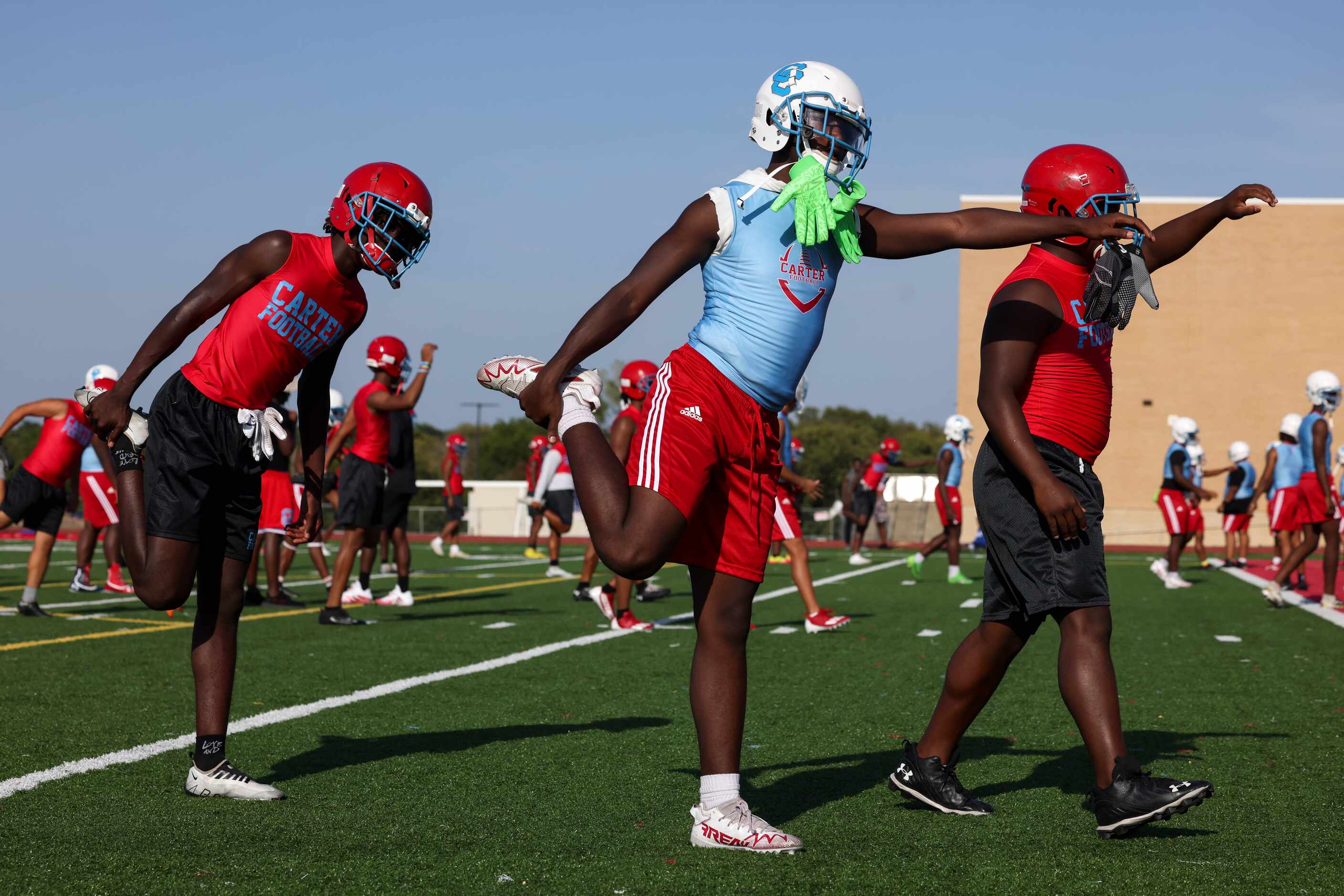 Players warm up for the first practice of the season at Carter High School in Dallas on...