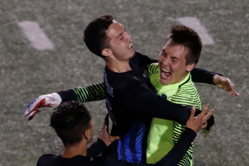 Hebron goalkeeper Matthew Hofmann (1), right, celebrates with teammates Tyler Davis (16),...