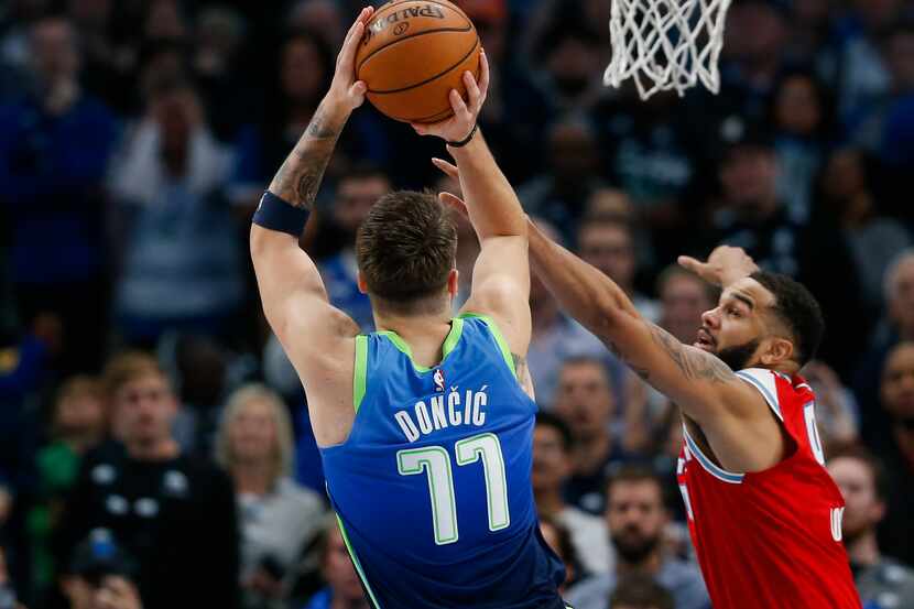 Sacramento Kings guard Cory Joseph (9) guards Dallas Mavericks forward Luka Doncic (77)...