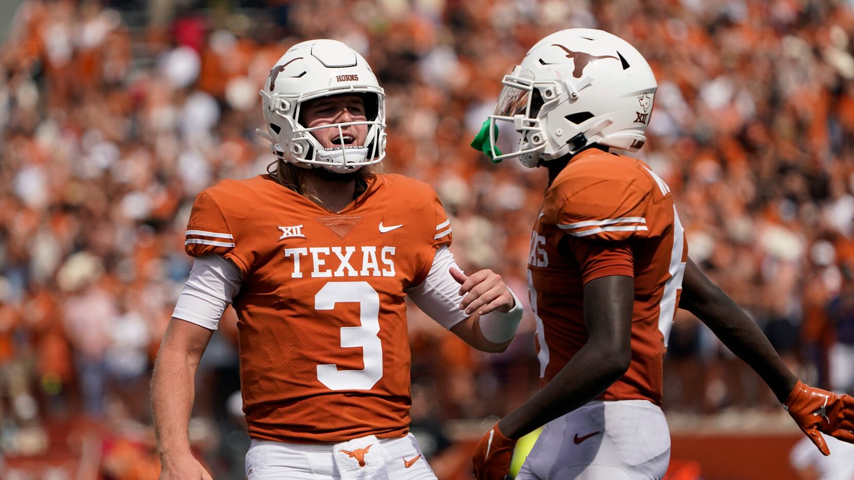 Texas quarterback Quinn Ewers (3) and wide receiver Xavier Worthy (8) celebrate after they...