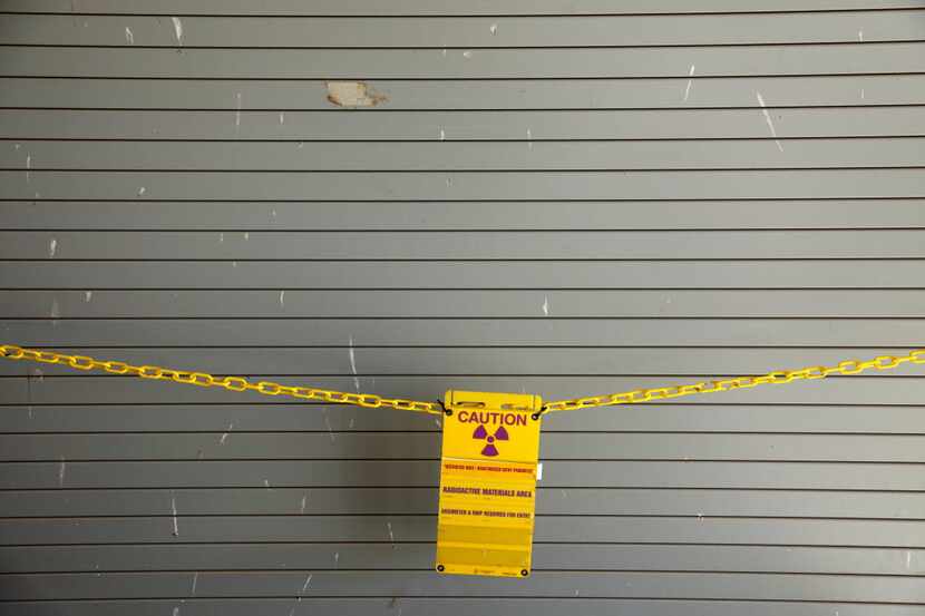 A radioactive caution signs hangs across a Container Storage Building door at Waste Control...