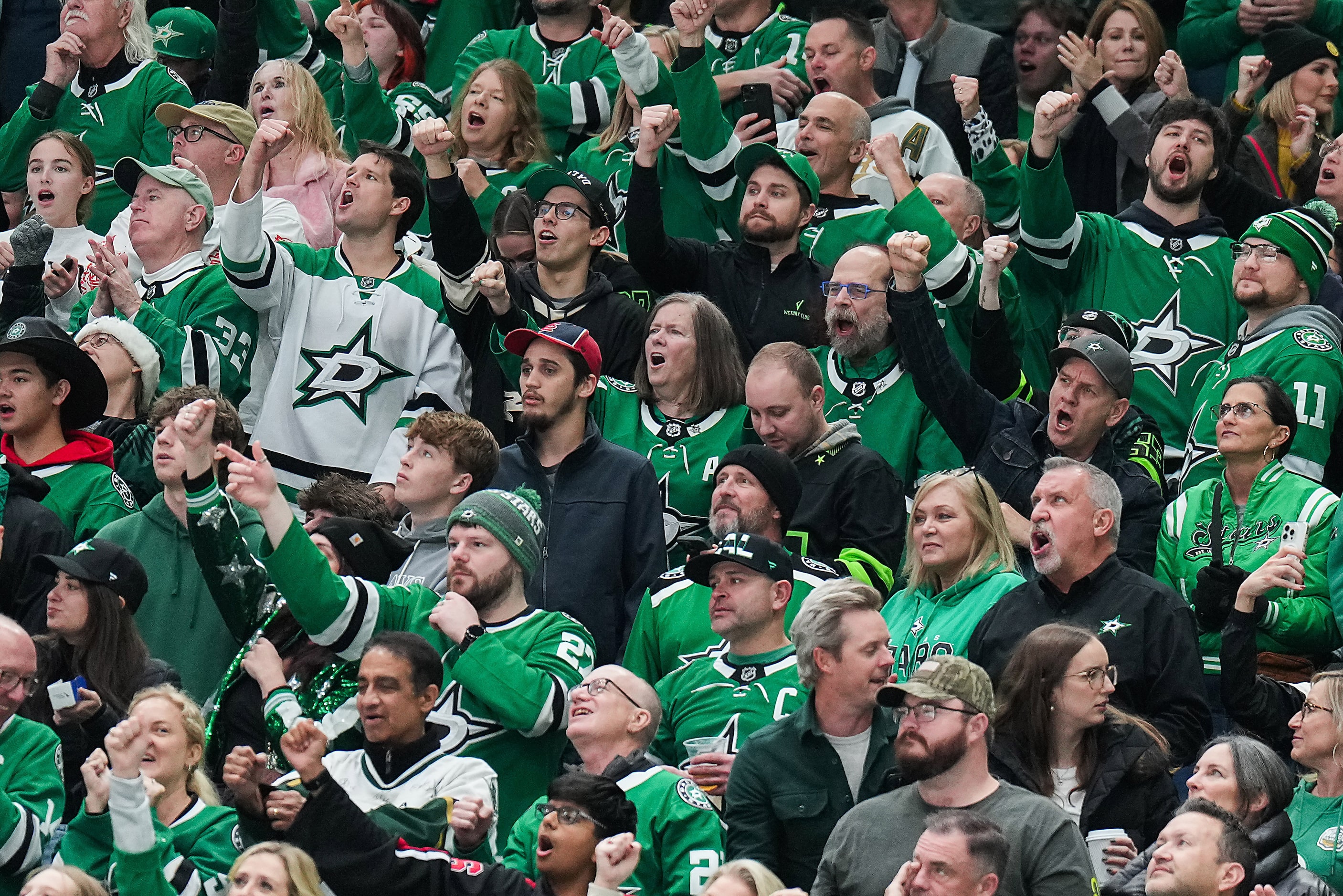 Dallas Stars fans cheer a goal by left wing Jason Robertson during the second period of an...