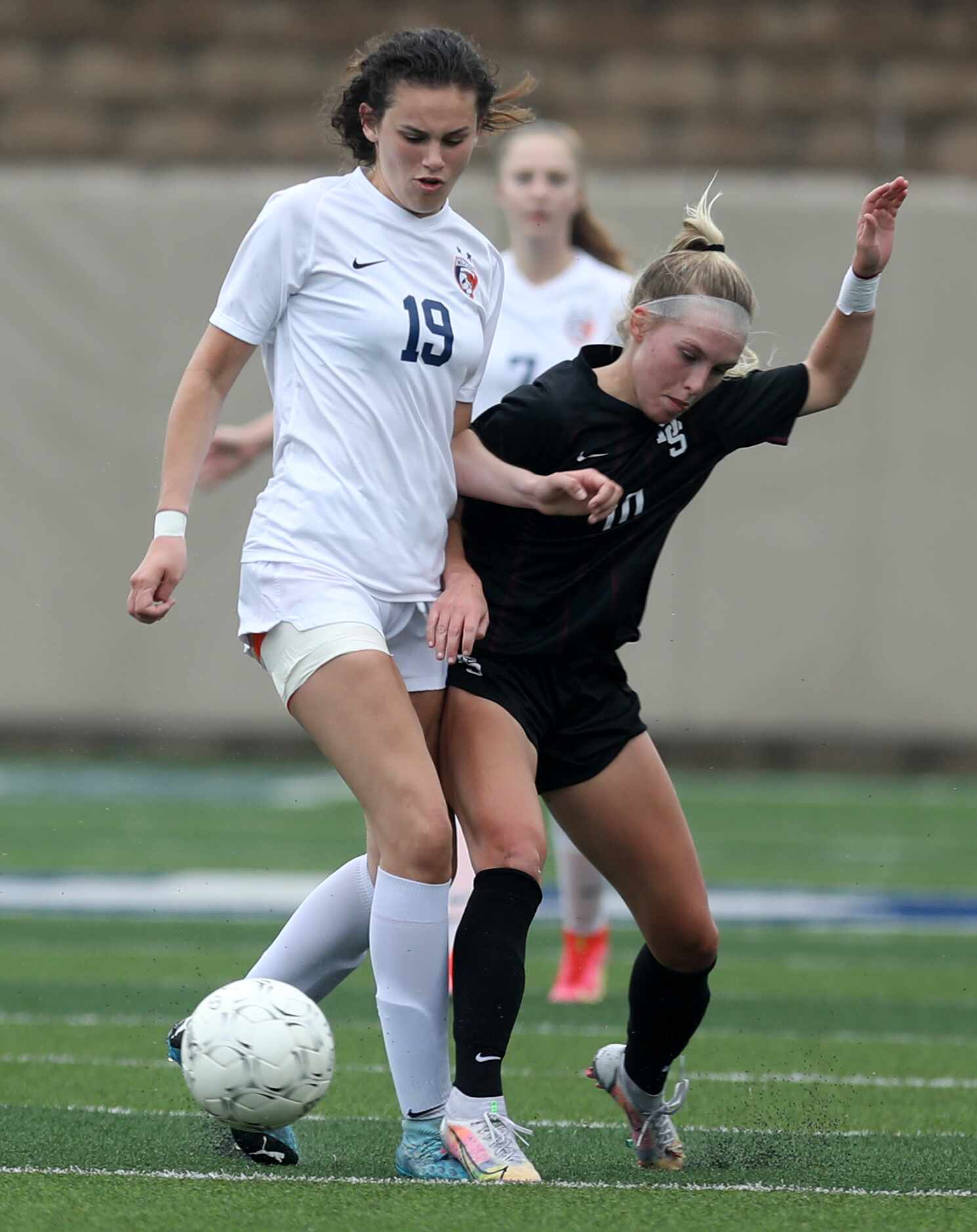 Wakeland's Faith Bell (19) and Dripping Springs' Riley Sisson (10) struggle for control of...
