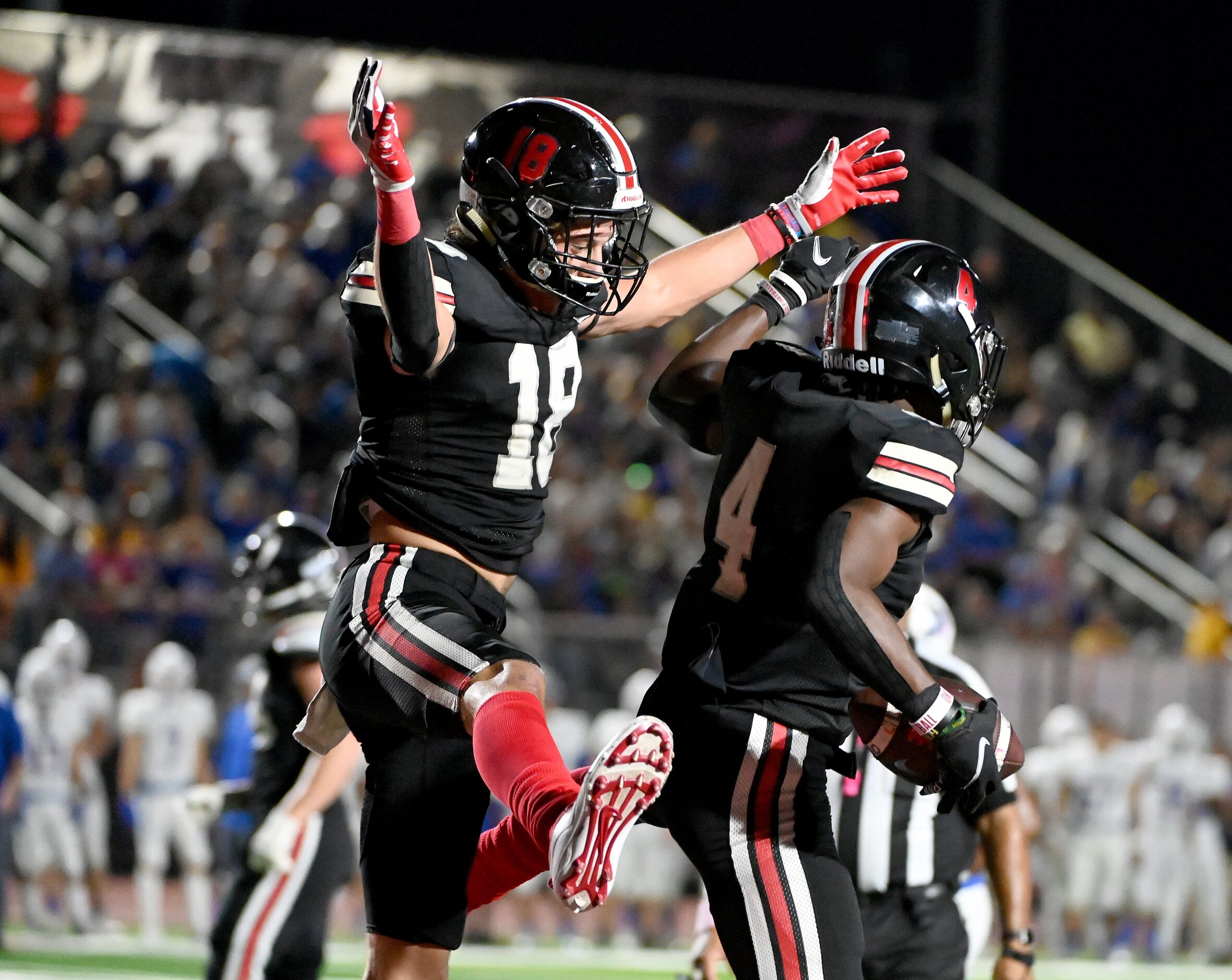 Lovejoy's Parker Livingstone (18) celebrates with Kyle Parker (4) after Parker’s touchdown...