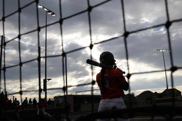 Frisco Wakeland's Claire Schreiner (15) waits her turn to bat in the on-deck circle in the...