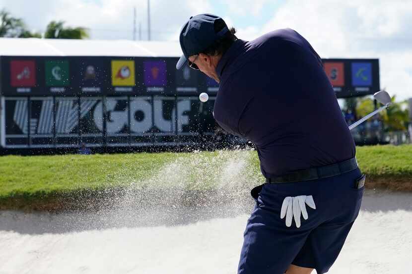 Phil Mickelson hits from a sand trap on the ninth hole during the first round of the LIV...