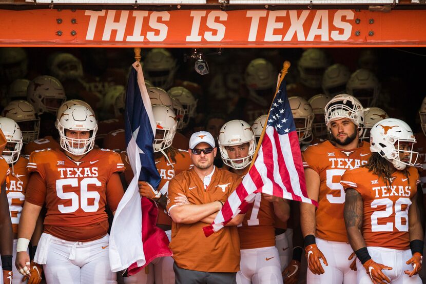 Texas Longhorns head coach Tom Herman waits in the tunnel with his team before a college...