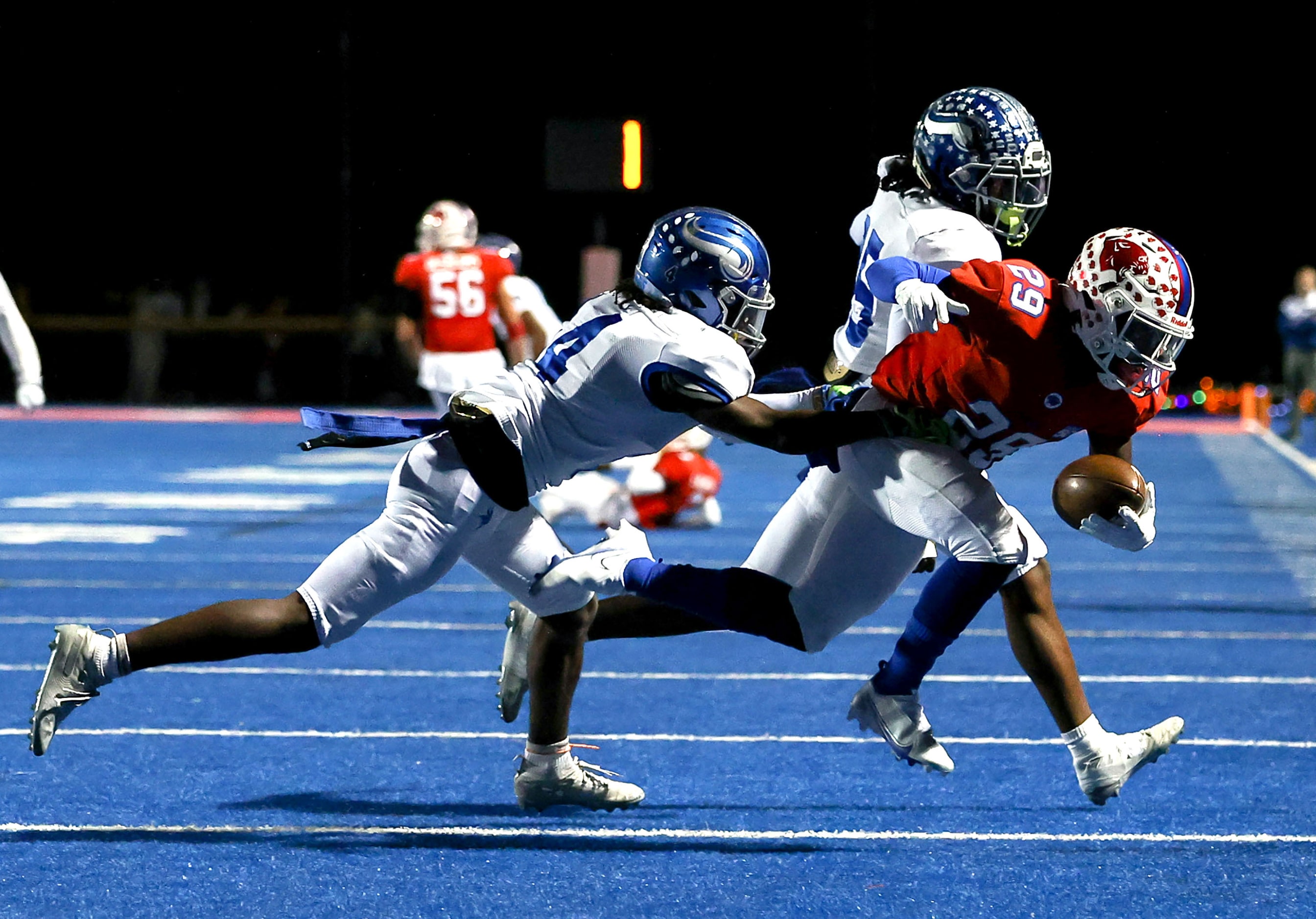 Parish running back Cedric Mays II (29) gets pushed ouf of bounds by Nolan defensive back...