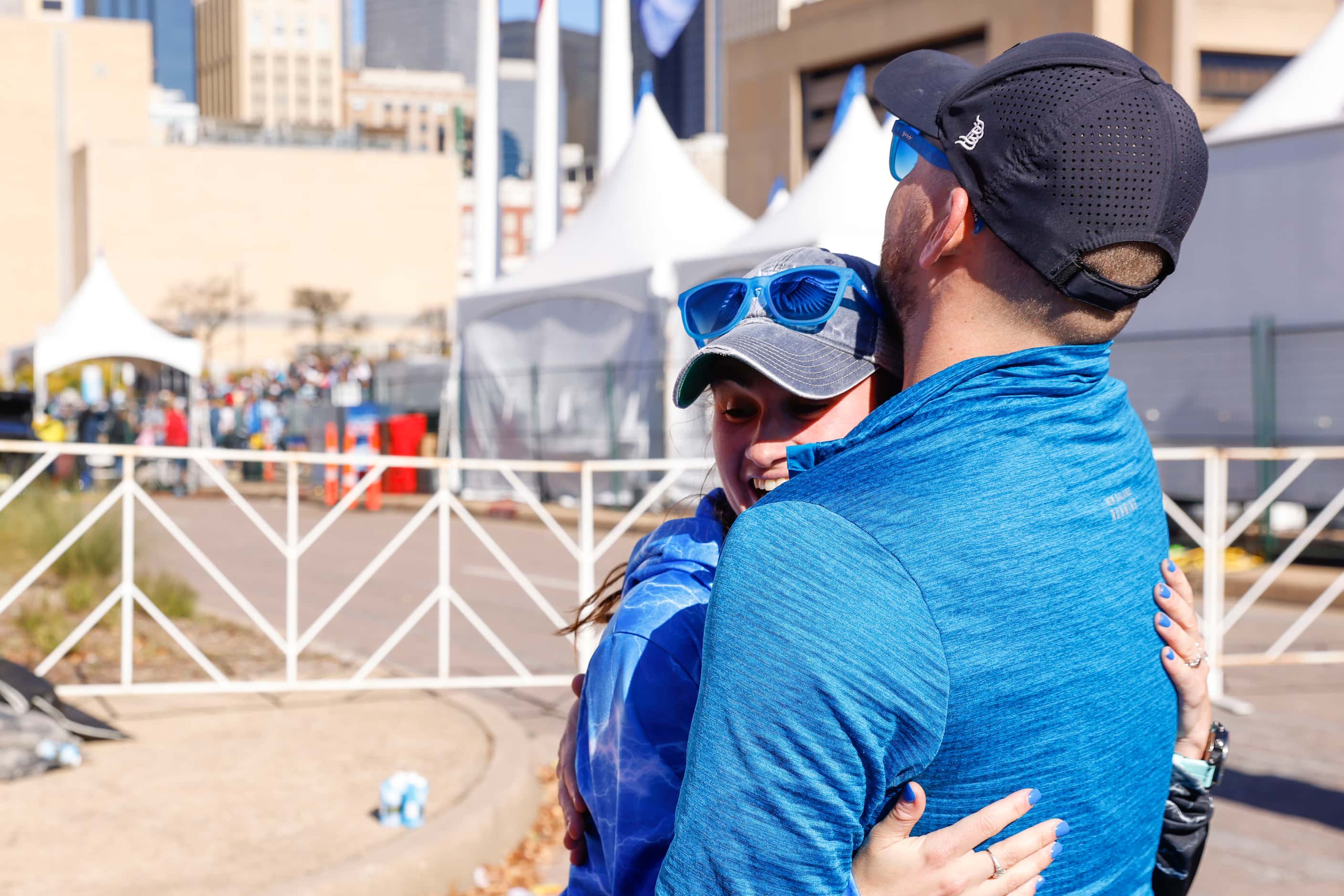 Women’s marathon finisher Jill Wolf of Dallas embraces her husband Paul during 2023 BMW...