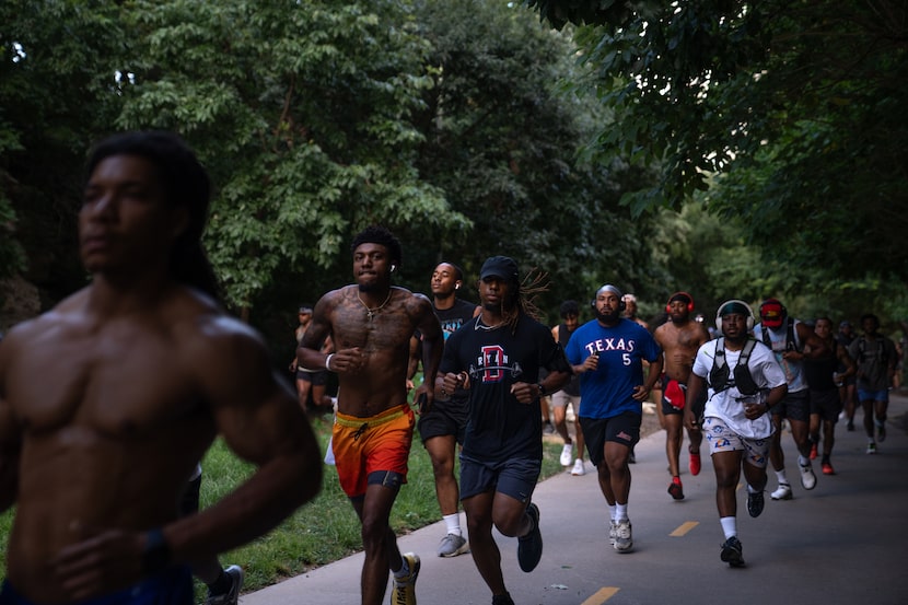 Runners with the group Run it Up make their way through the Katy Trail in Dallas, Texas on...