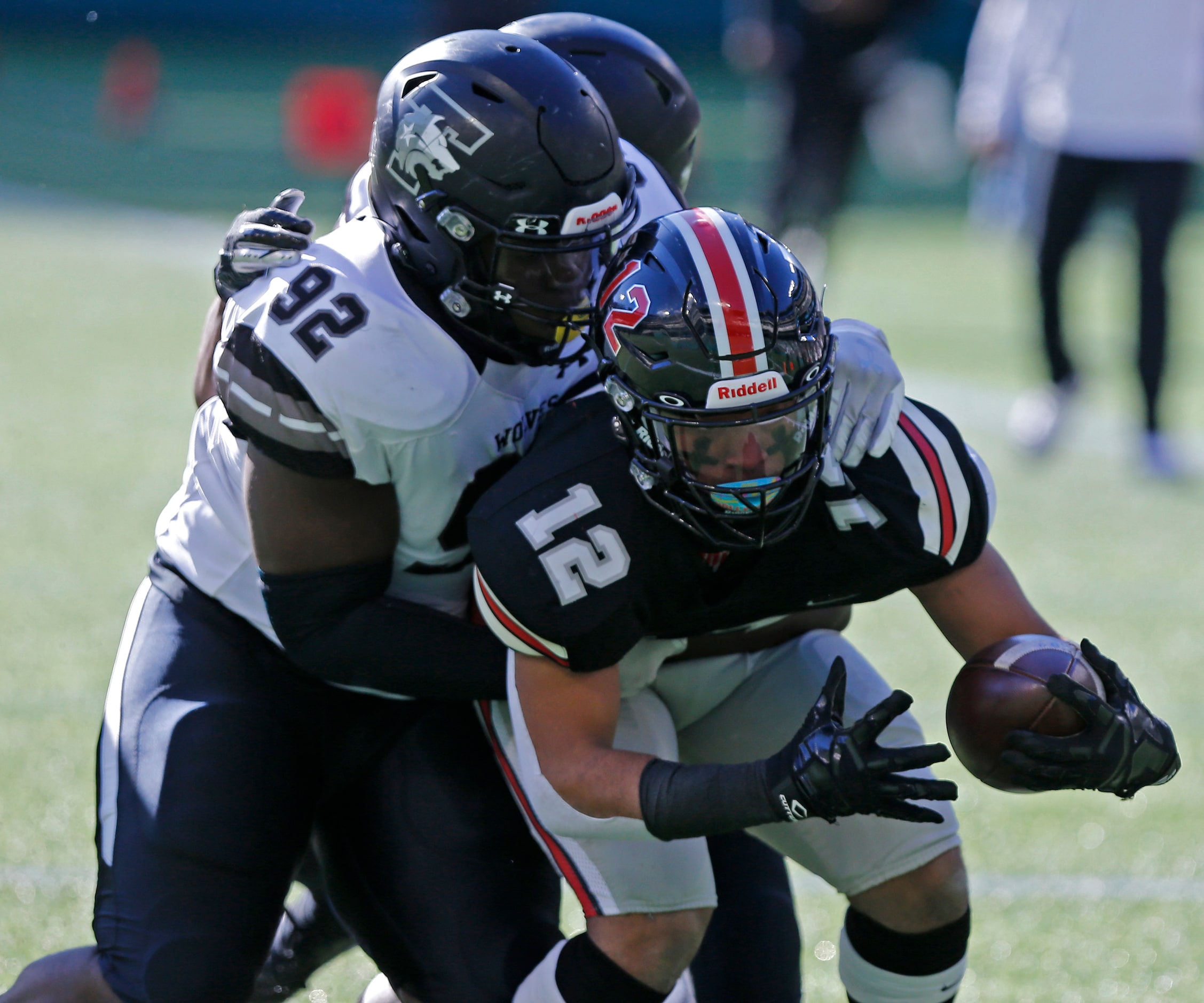 Lovejoy High School running back Noah Naidoo (12) is tackled by Mansfield Timberview High...