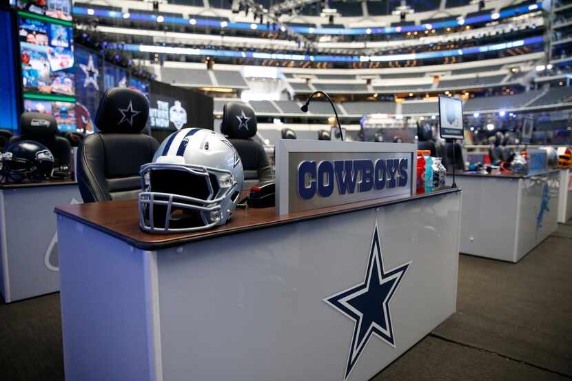 A desk for the Cowboys representatives is set during the NFL Draft at AT&T Stadium in...
