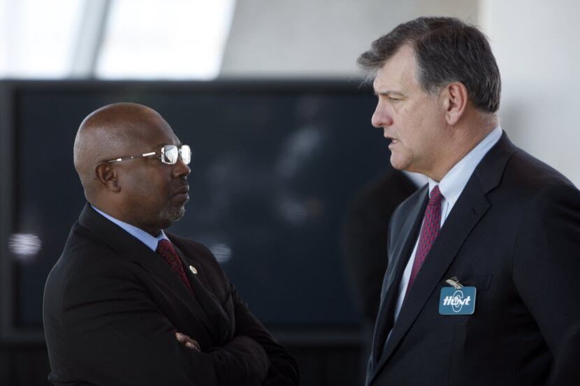 Dallas City Council member Tennell Atkins (left) speaking with Mike Rawlings.