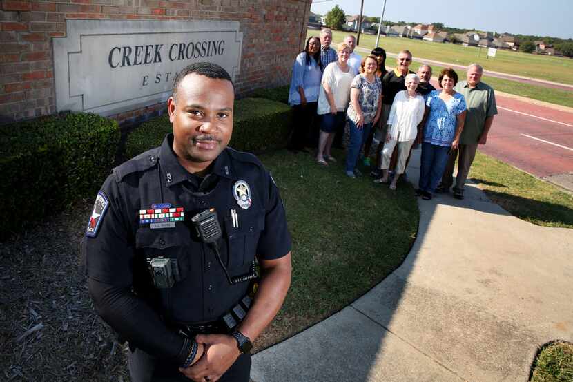 Mesquite crime prevention officer Torrey Rhone poses for a photograph with members of the...
